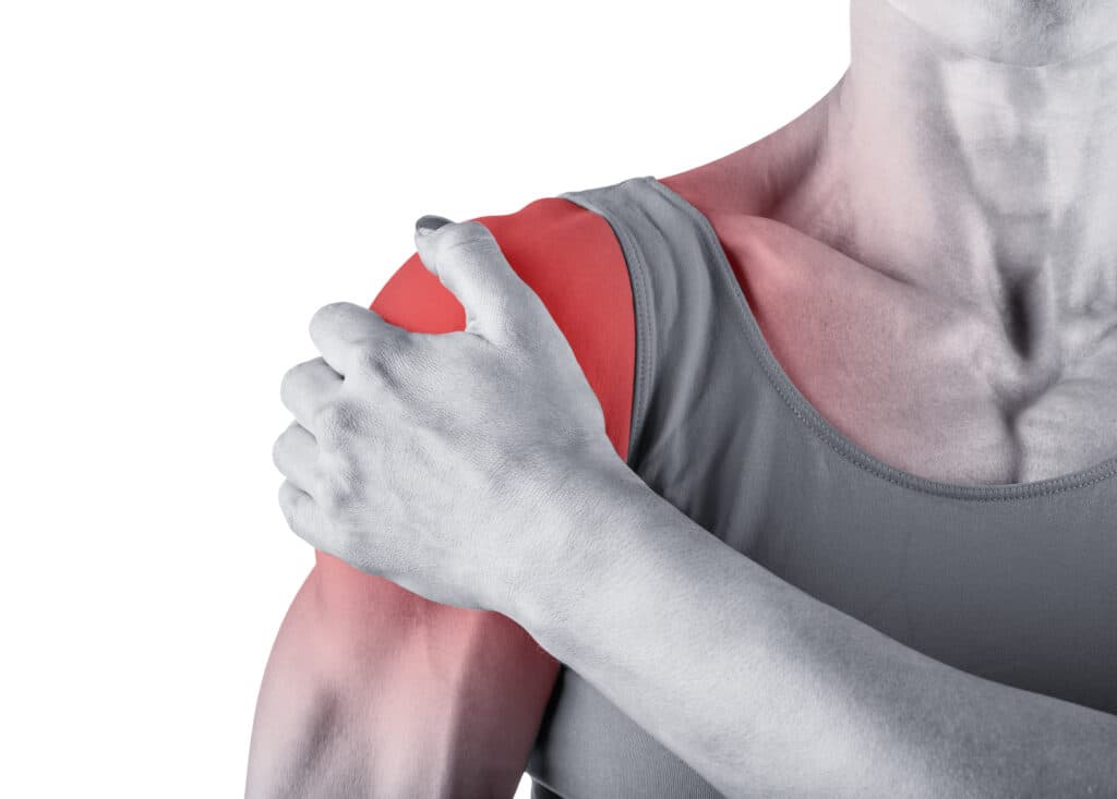 Person holding painful shoulder — frozen shoulder adhesive capsulitis treatment, Forest Hills Queens NY