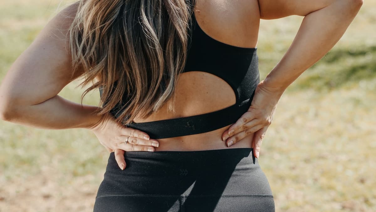 Person with lower back and pelvic discomfort related to tailbone pain coccydynia treatment