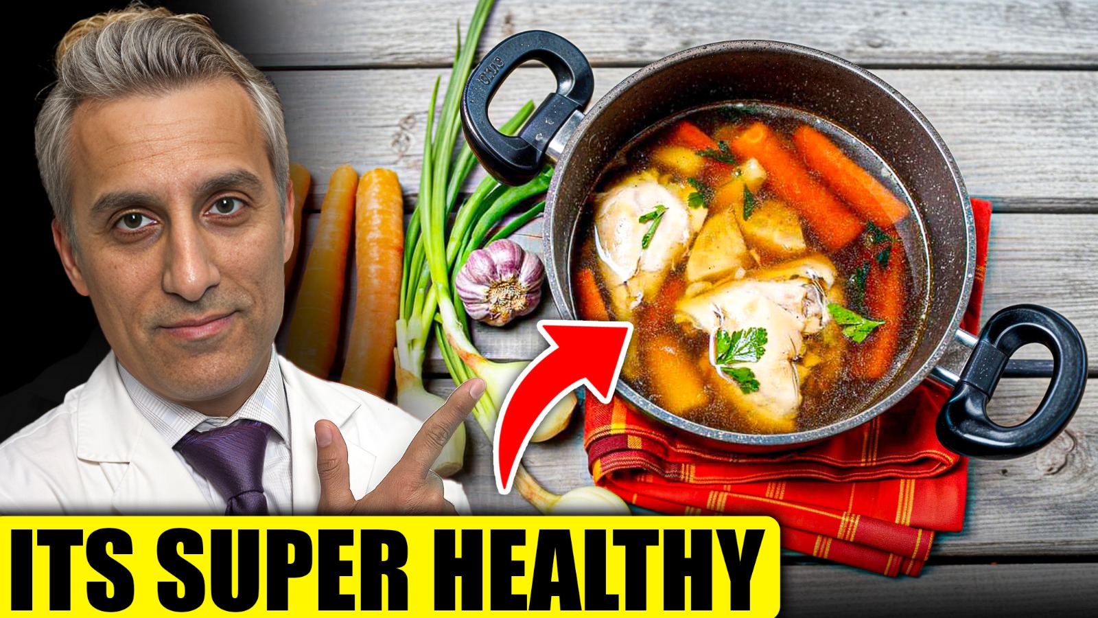 A man points to a pot of healthy, simmering vegetables and chicken broth.